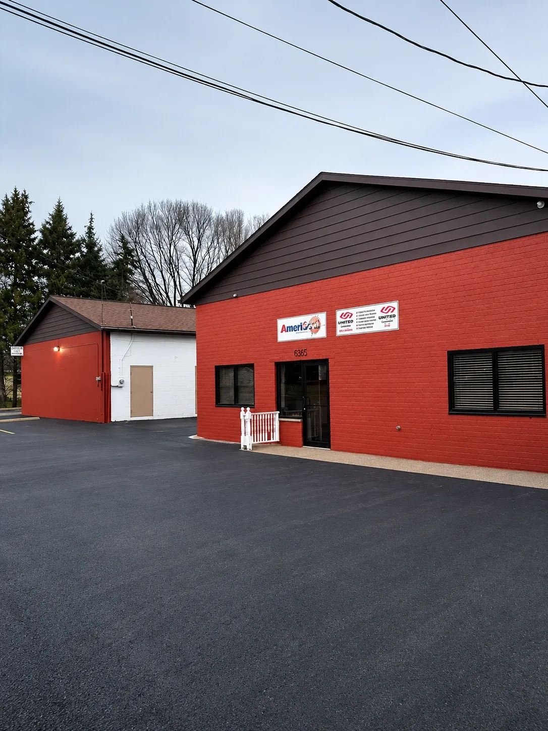 Commercial building exterior finished in red with dark trim