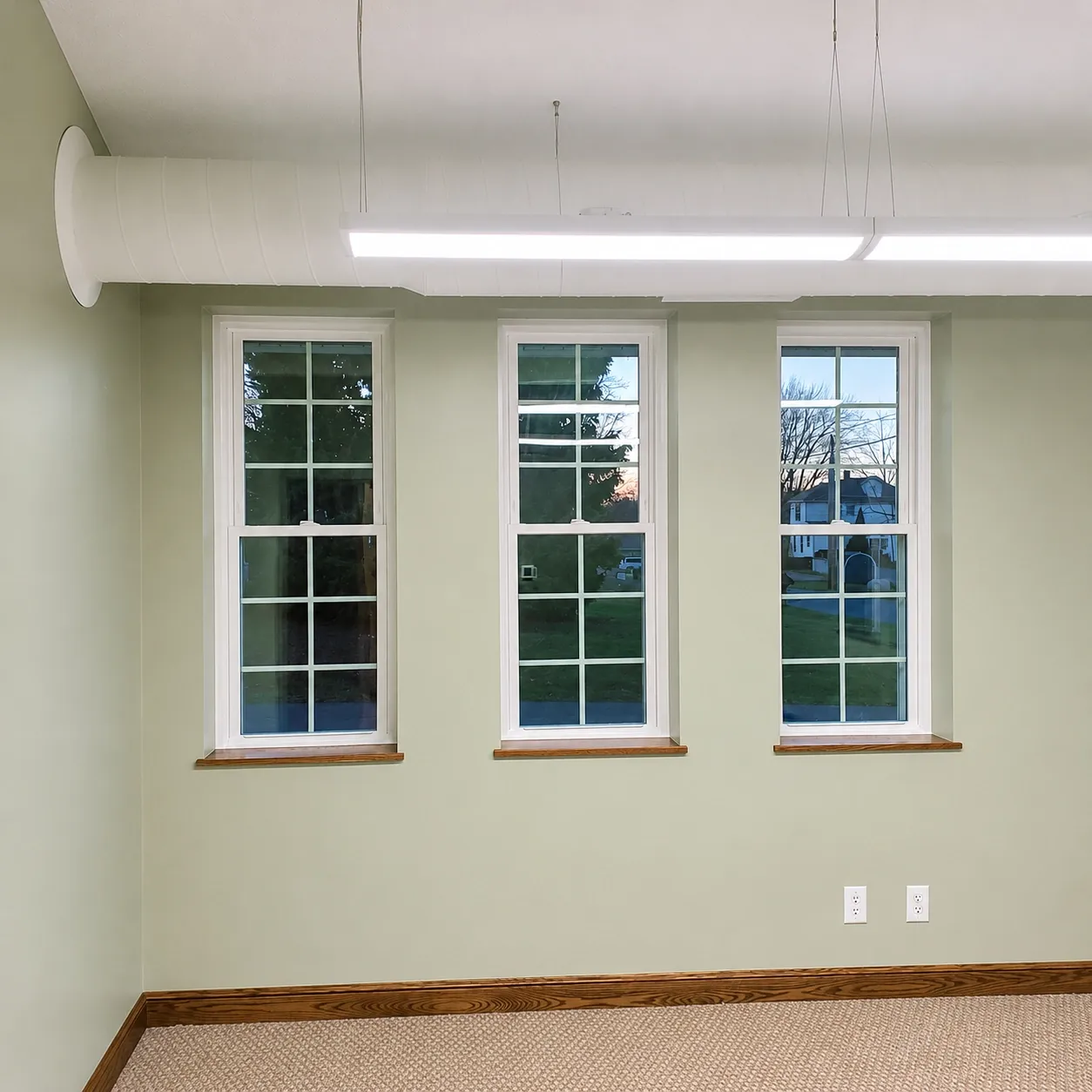 Commercial interior with light neutral walls and tall windows