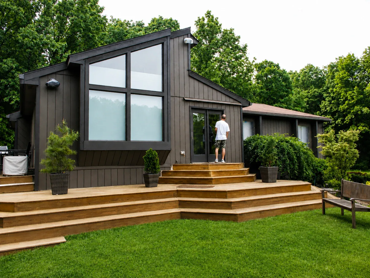 Contemporary home exterior with dark neutral siding and warm wood details