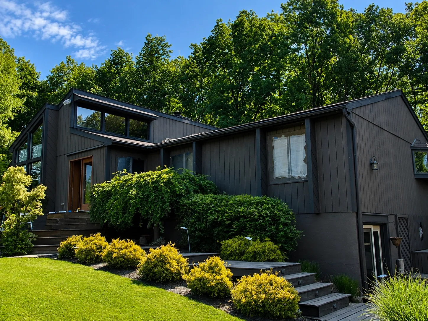 Residential exterior finished in a deep neutral color