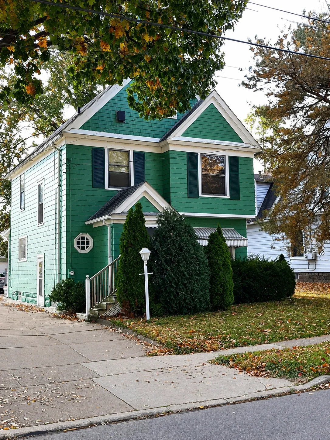 Teal residential exterior with white trim and accents