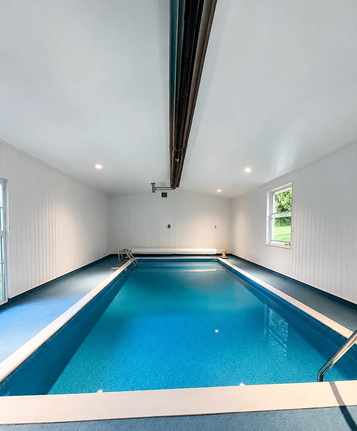 Finished white interior surrounding a private indoor pool