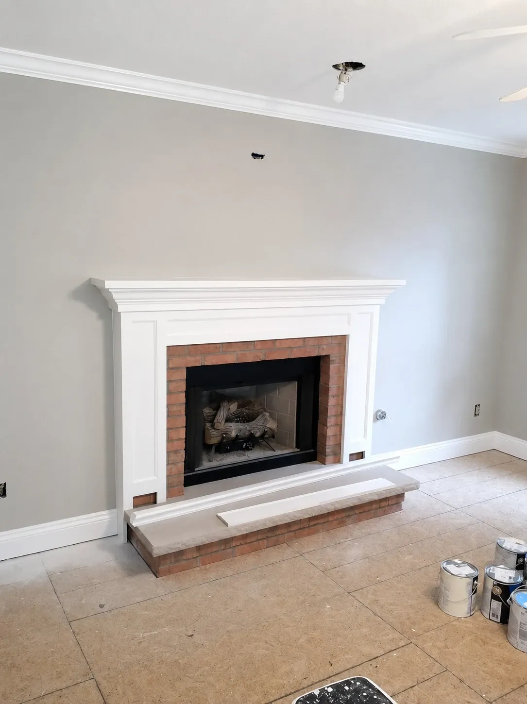 Light gray painted room with white fireplace trim